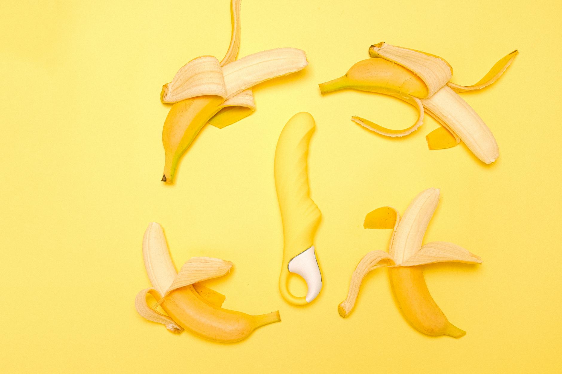 A yellow lemon vibrator surrounded by fresh lemons on a bright yellow background, illustrating the balance of gentle and powerful stimulation.