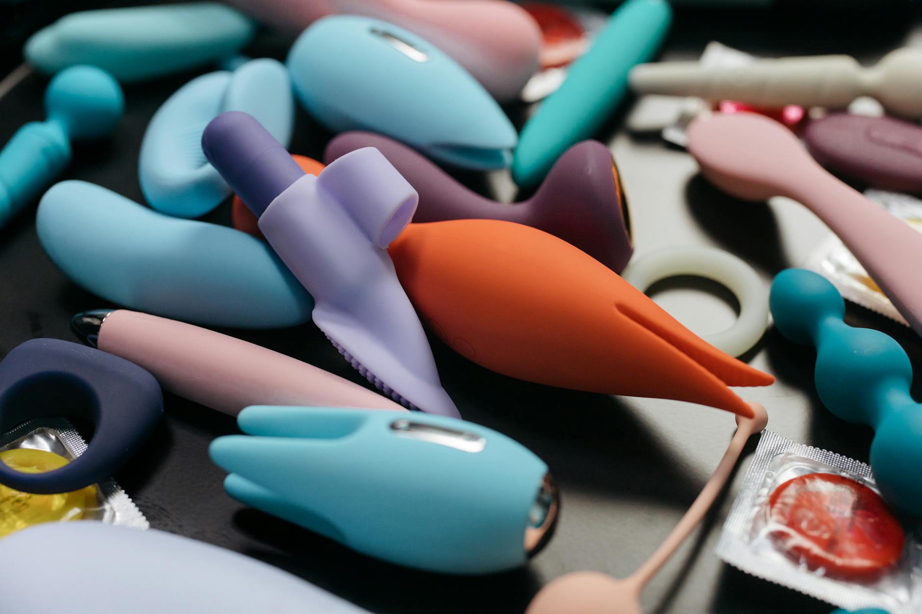Hands holding a sleek blue vibrator, intimate connection to personal pleasure